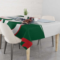 Green tablecloth with horse-rider scene and red-white-green swirl pattern on table