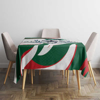 Green tablecloth with horse-rider graphic and red-white-green swirl bands on tabletop