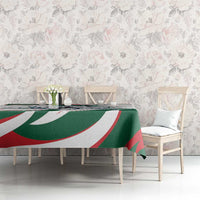 Green tablecloth with horse-rider print and red-white-green swirl border across table
