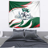 Green and white horse rider tapestry with Saudi flag waves and skyline scene above bed