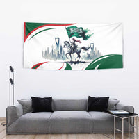 Green and white horse rider tapestry with Saudi flag waves, skyline, and Arabic emblem