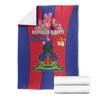 Haiti coat of arms flag blanket folded with stack of white towels, blue border and red center