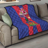 Haiti flag quilt on sofa with blue quilted texture and red center panel with crest