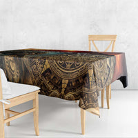 Dark gold and black Aztec warrior tablecloth with patterned border, draped on table