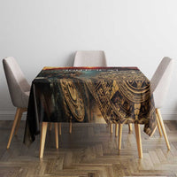 Dark Aztec patterned tablecloth with ornate circular motifs on wooden dining table