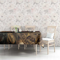 Dark gold and black Aztec patterned tablecloth on rectangular table with two chairs