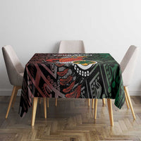 Black Aztec-style tablecloth with green and red graphic warrior sun motif