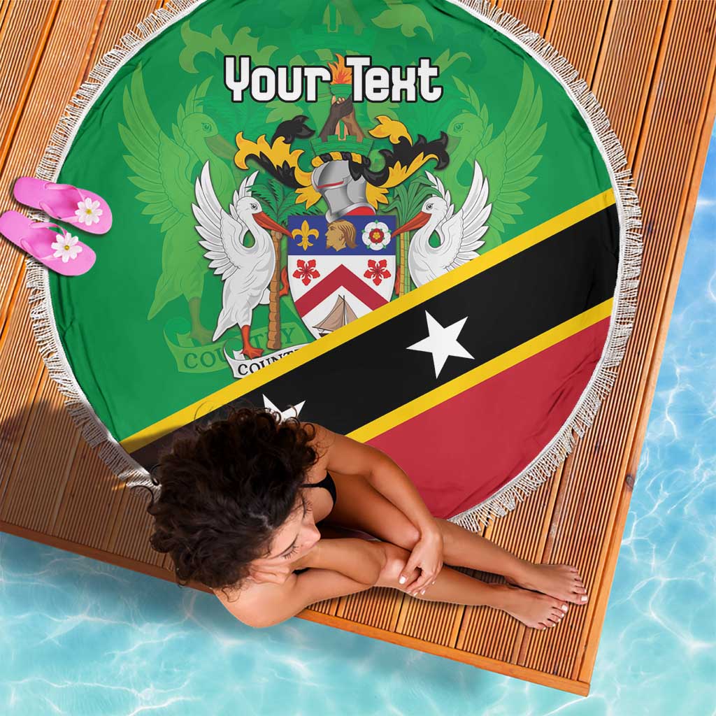 Green round beach blanket with white fringe, crest design and 'Your Text', laid on mat