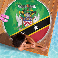 Green round beach blanket with white fringe, crest design and 'Your Text', laid on mat