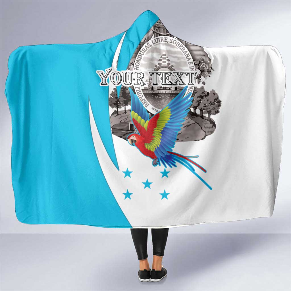 Hooded blanket, blue-and-white with colorful macaw and circular coat-of-arms graphic