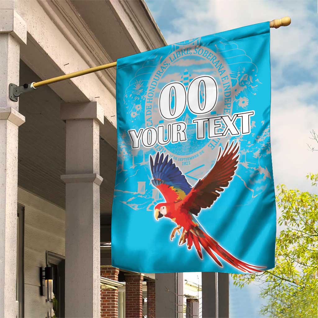 Blue garden flag with scarlet macaw and custom 'YOUR TEXT' design, hanging on a pole