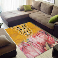 Yellow and pink floral area rug with central paisley medallion pattern