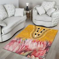 Yellow area rug with pink floral field and dark paisley medallion center