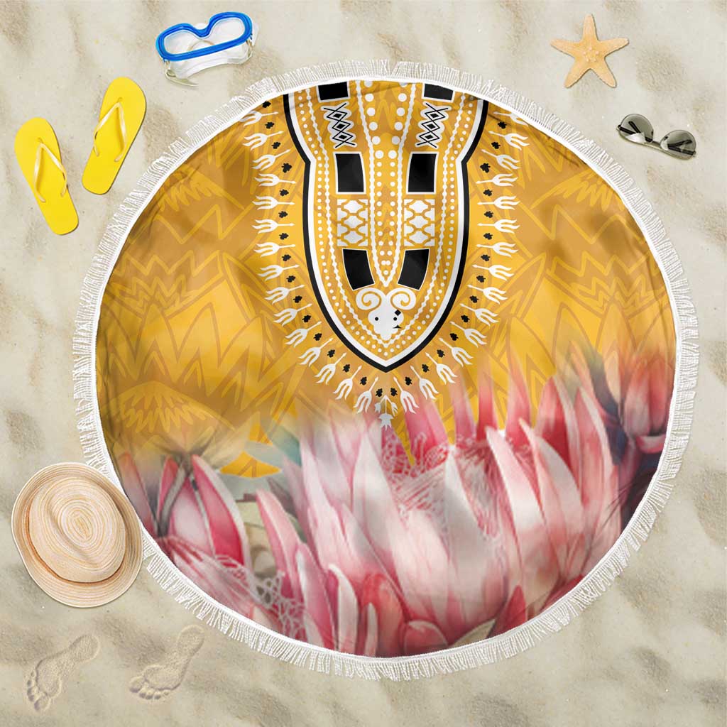 Round beach blanket with yellow tribal print, pink floral rays, white fringed edge