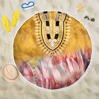 Round beach blanket with yellow tribal print, pink floral rays, white fringed edge