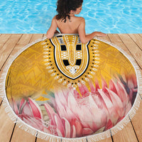 Round beach blanket on deck: yellow tribal motif, pink floral rays, white fringed border