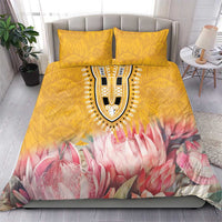 Yellow bedding set with pink protea floral design, central medallion, and matching pillow pair