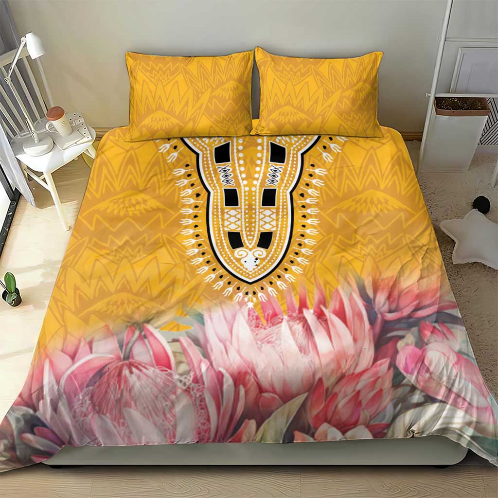 Yellow duvet cover with pink protea floral print and tribal-style central emblem, two pillows
