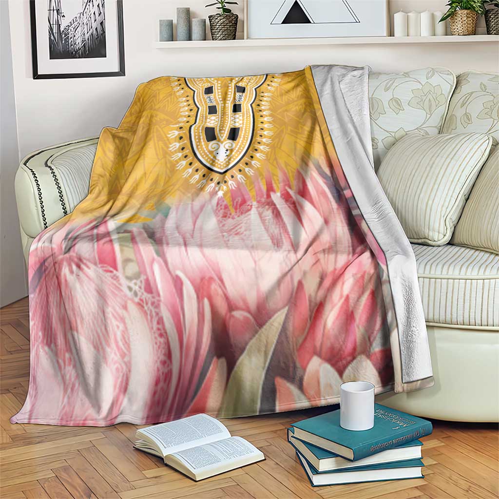 Yellow and pink protea floral king blanket draped over sofa