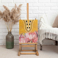 Yellow canvas wall art on wooden easel with tribal U-pattern and pink protea flowers