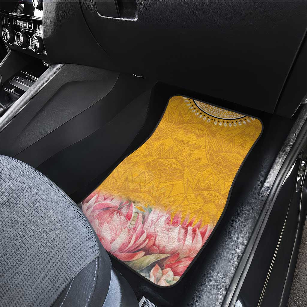 Yellow car floor mat with geometric pattern and pink floral protea motif, front seat