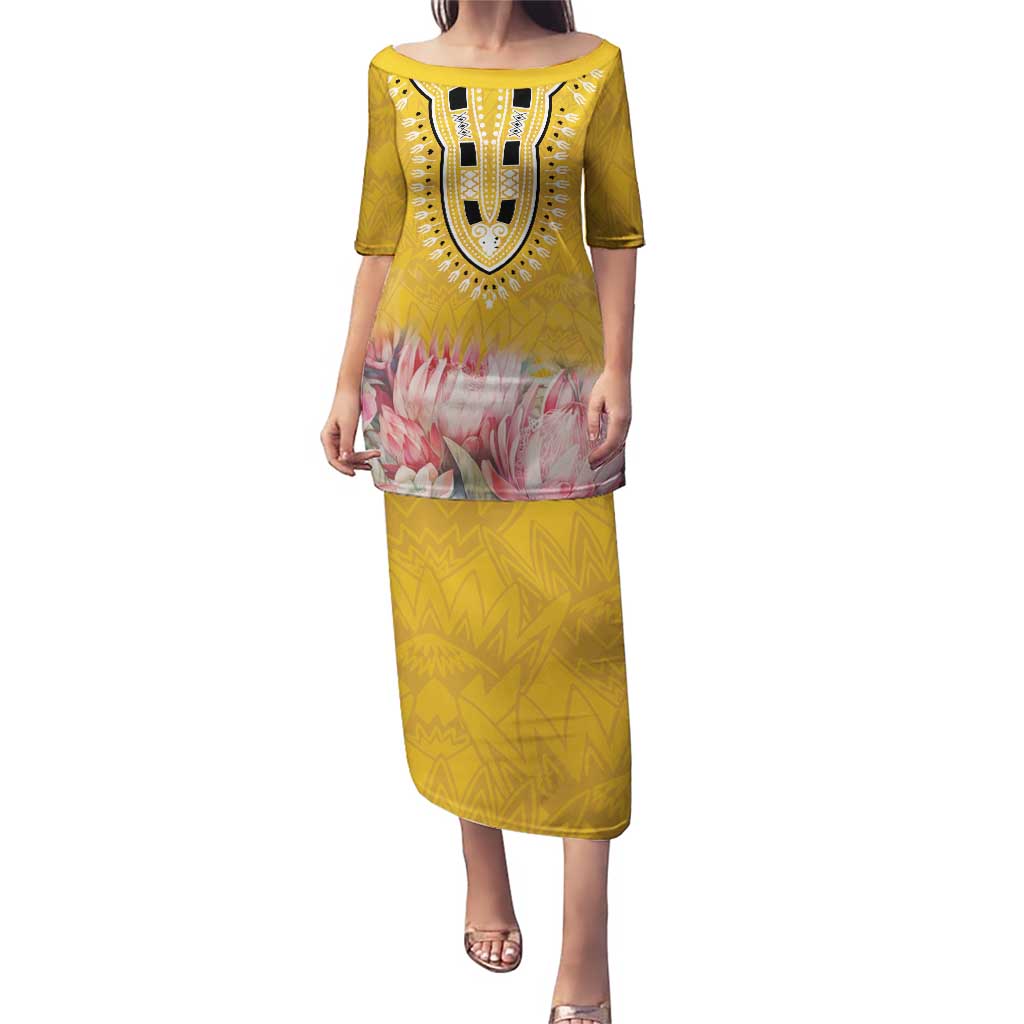 Yellow long dress with dashiki neckline, pink floral hem panel, and patterned skirt