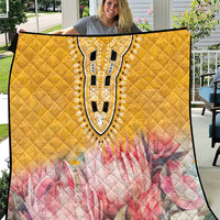 Yellow quilt with pink floral print and ornate black-and-white dashiki-style central motif