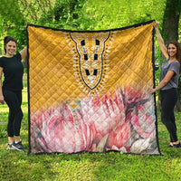 Yellow quilt with diamond stitching, pink floral panel, and black-and-white dashiki medallion
