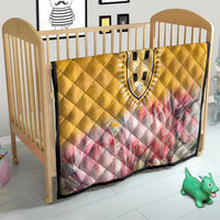 Yellow quilt for crib with pink floral panel and decorative black-and-white dashiki center
