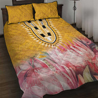 Yellow quilt bed set with bold oval dashiki motif and pink floral pattern, with matching pillows