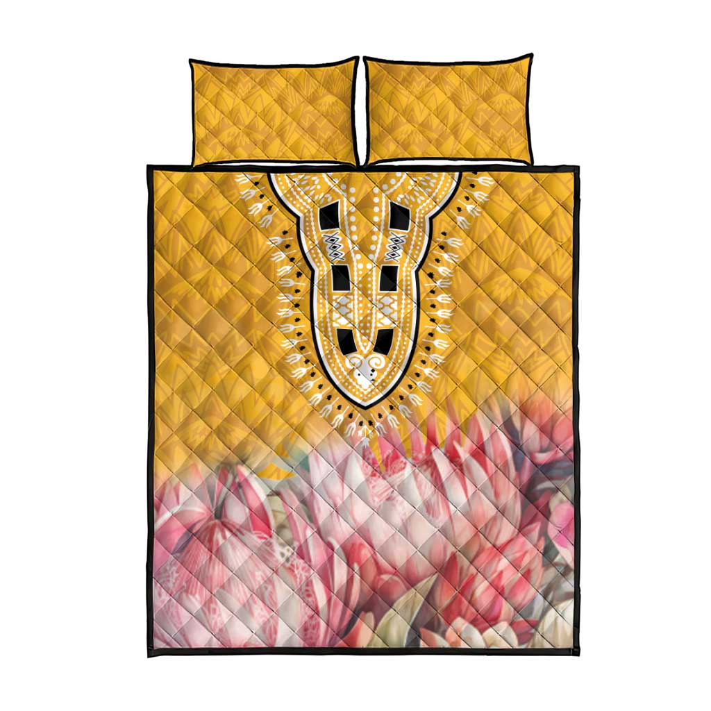Yellow quilt bed set with centered dashiki oval motif, pink floral band, plus two matching pillowcases