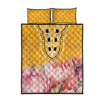 Yellow quilt bed set with centered dashiki oval motif, pink floral band, plus two matching pillowcases