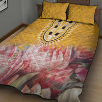 Yellow quilt with central black-and-white dashiki oval and pink floral quilted pattern, with two pillows