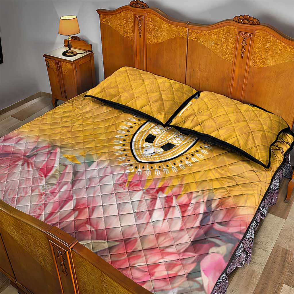 Yellow quilt bed set with dashiki oval medallion, pink floral wave bottom, two quilted pillow shams