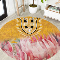Round rug close-up: yellow geometric border, black-and-white center, pink petal pattern