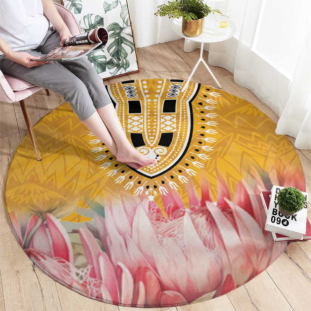 Round rug on hardwood floor with yellow medallion and pink petal-like pattern