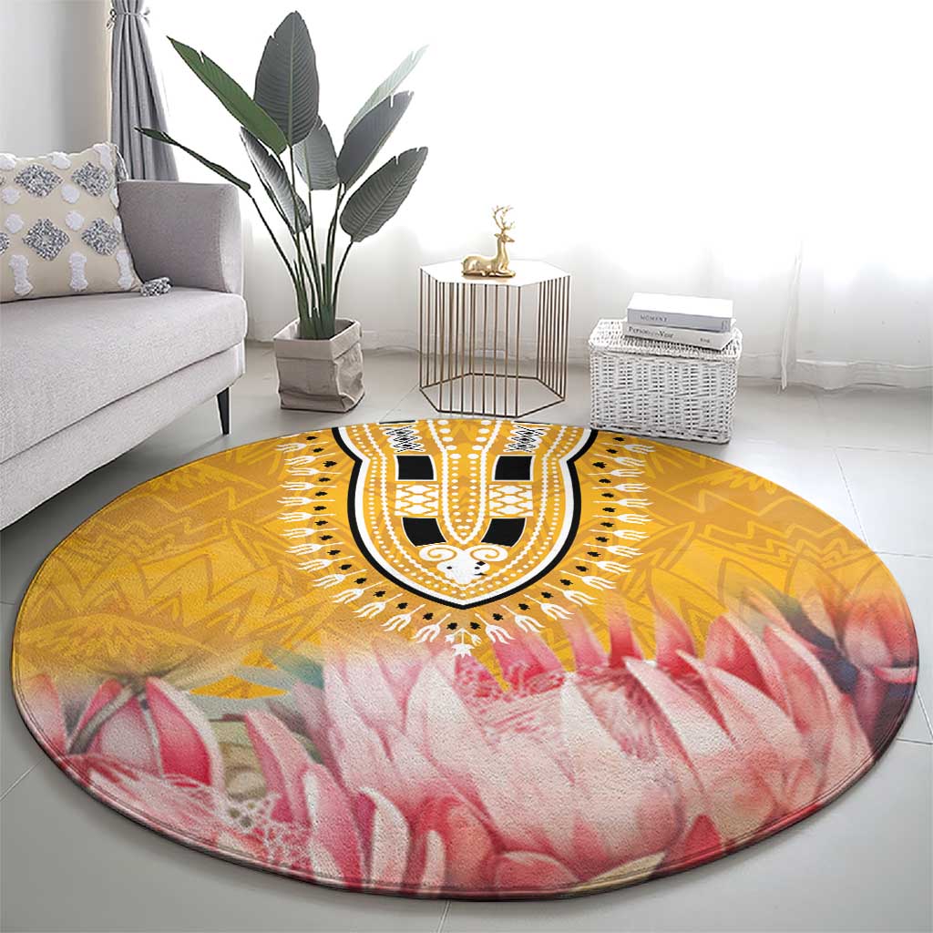 Round yellow and pink floral motif rug with black-and-white center medallion