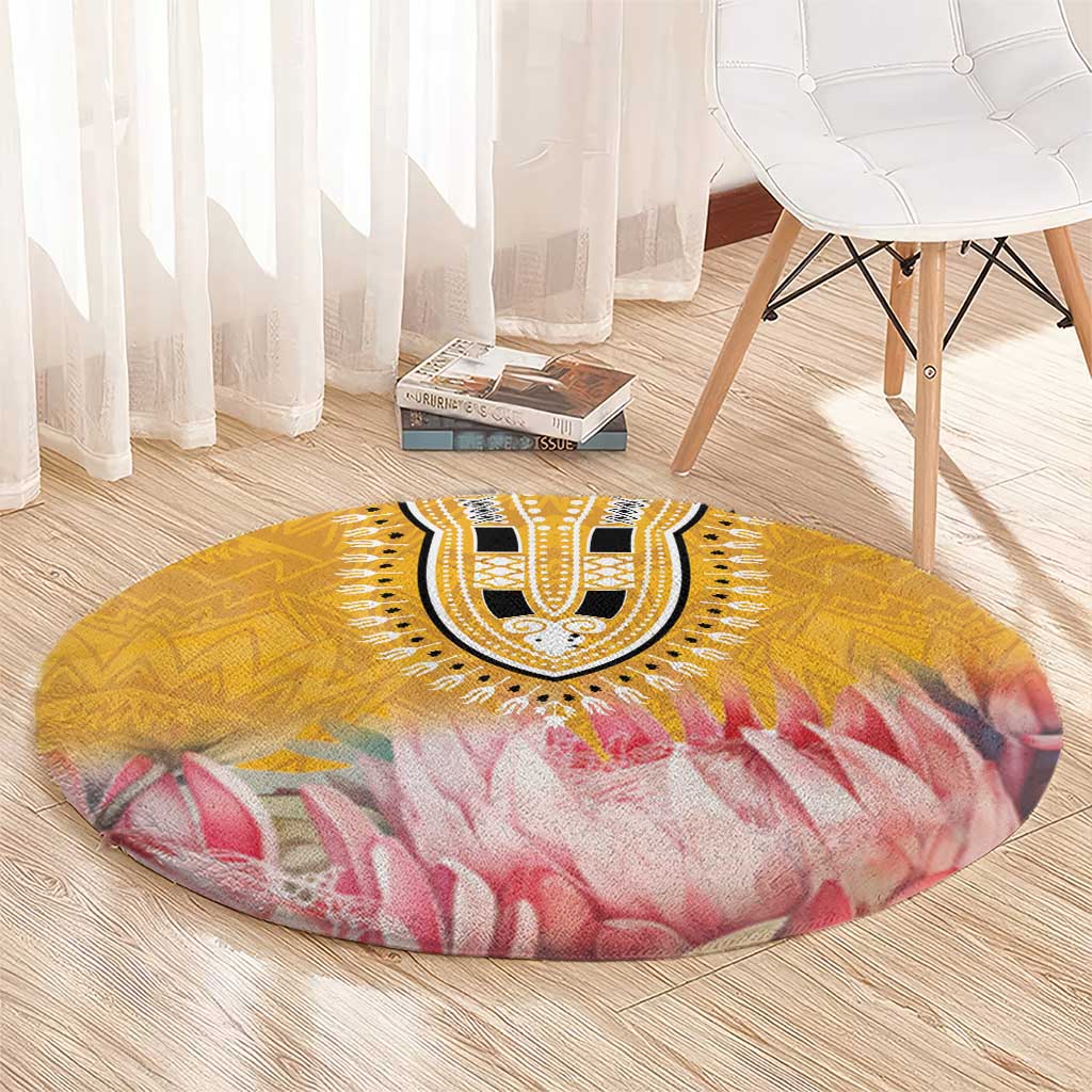 Round yellow and pink floral motif rug with black-and-white center medallion