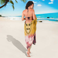 Yellow floral sarong with ornate shield center and adjustable tie straps at back