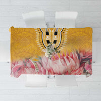 Rectangular floral tablecloth with yellow base, pink petals, and ornate black center motif