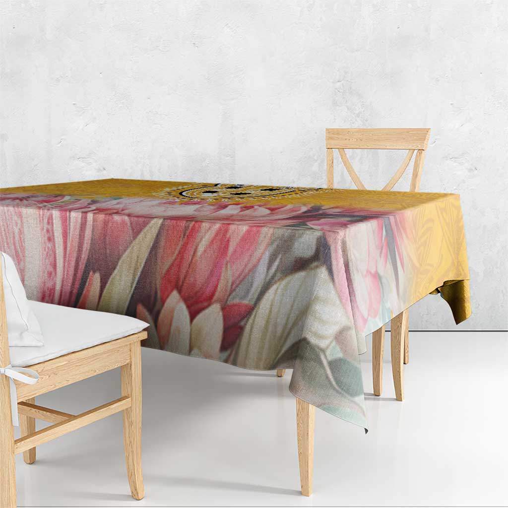 Floral tablecloth with pink, green, and yellow tones, draped edge over dining table
