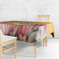 Floral tablecloth with pink, green, and yellow tones, draped edge over dining table