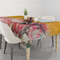Floral tablecloth with pink rose blossoms and yellow accents, draped on rectangular table