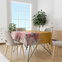 Floral tablecloth with pink flowers and yellow background, spread over dining table