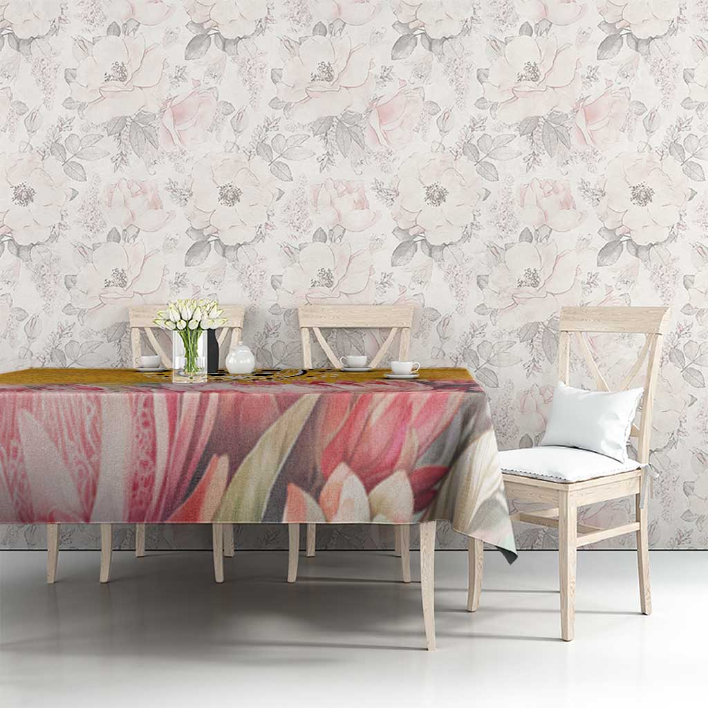 Floral tablecloth with pink and beige petals on a yellow background, draped over table