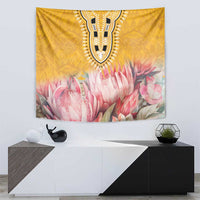 Yellow tapestry featuring black ornamental motif and pink protea and petal flowers