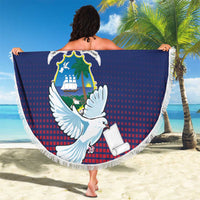 Round beach blanket draped by person: blue-red dove crest design with white fringe border