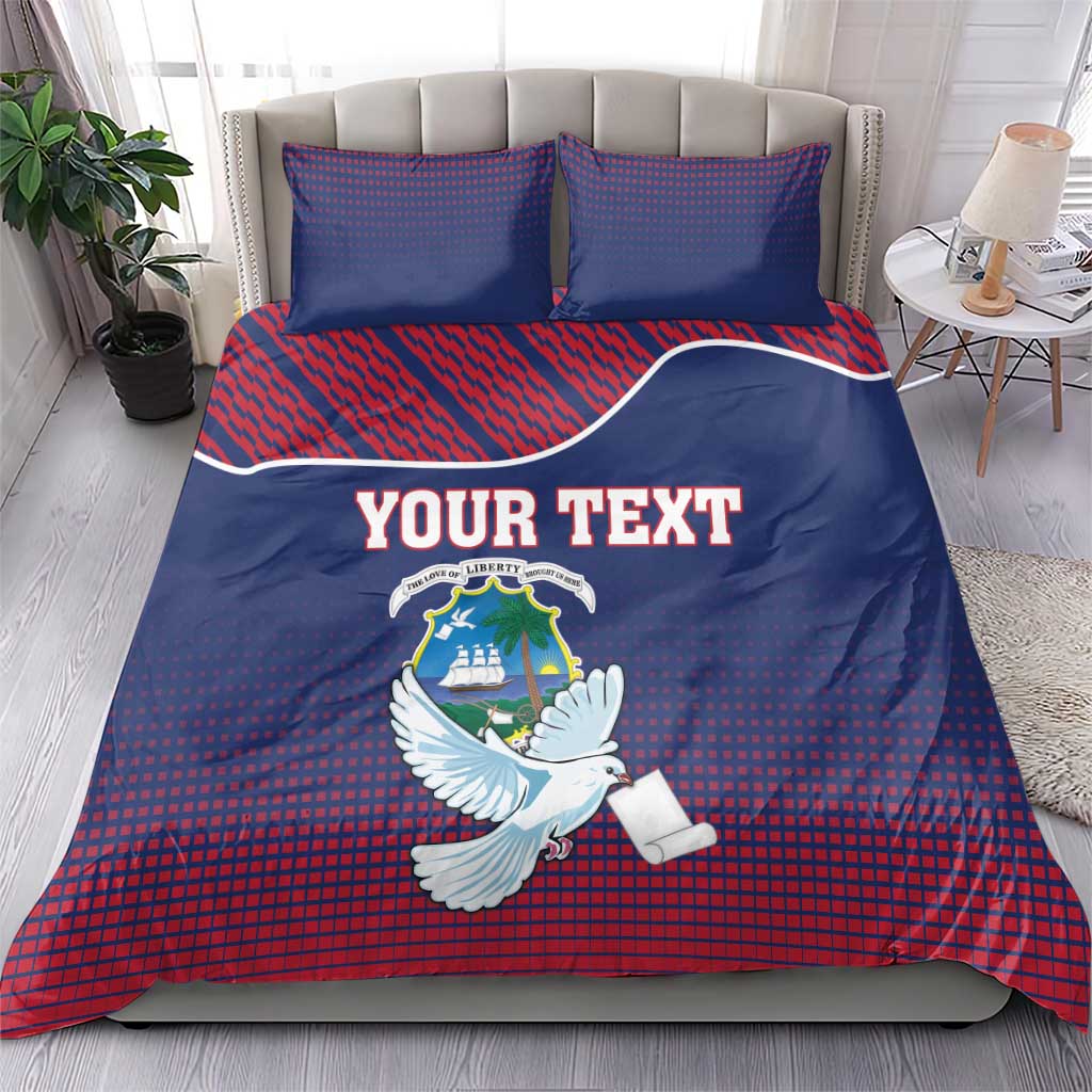 Blue and red patterned duvet set with Liberia crest, white dove, and “YOUR TEXT” text, 2 pillows.