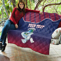 Personalized quilt blanket with Liberia dove and coat of arms, blue and red draped on couch