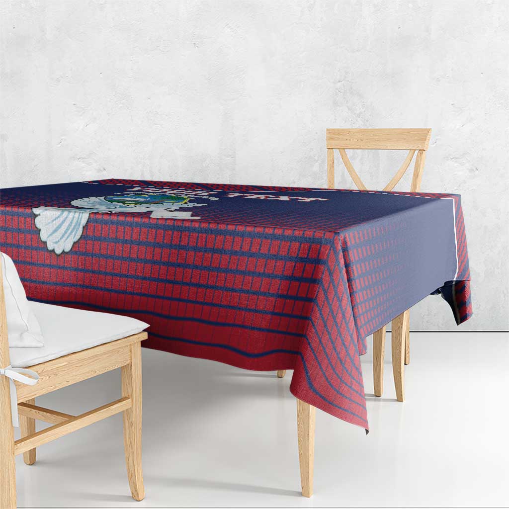 Navy and red Liberia-style tablecloth with dove emblem draped on dining table